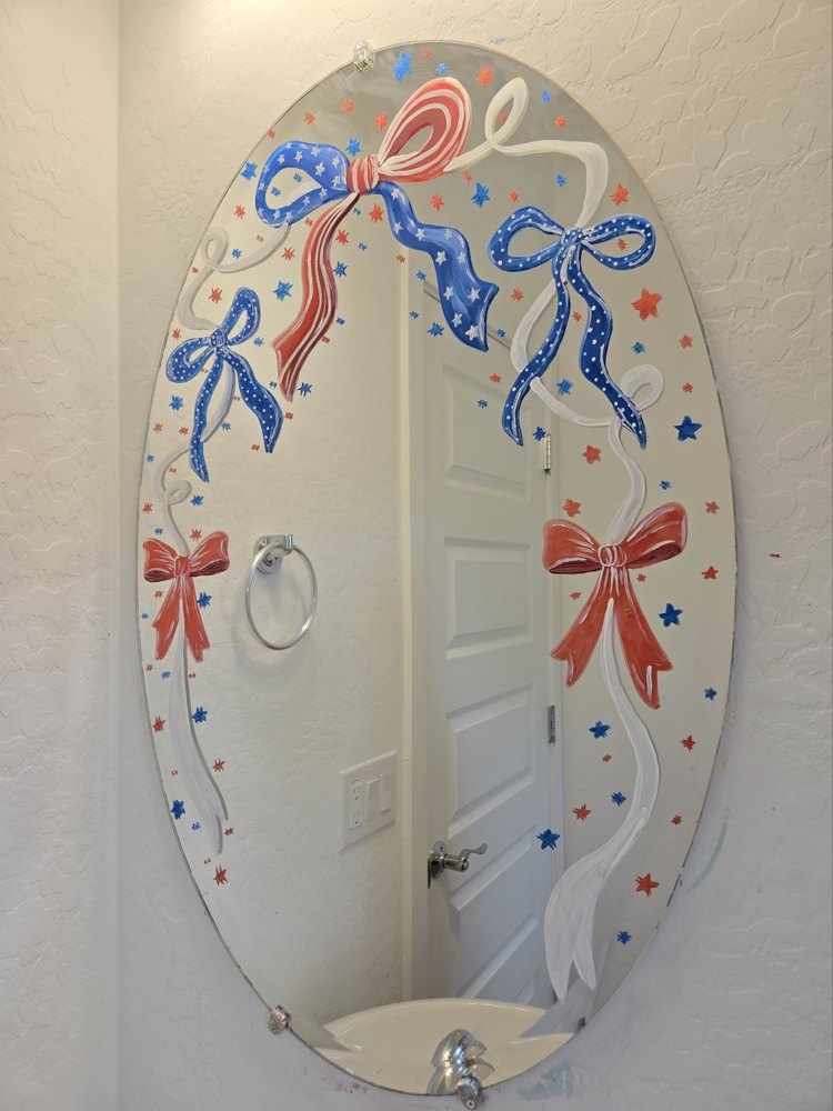 A mirror hand-painted with patriotic red, white and blue bows